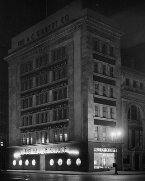 The Hall of Science at night including the American Flyer display window on the 5th Ave. side of the building - Photo by F. M. Demarest